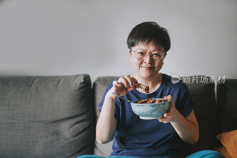 an asian chinese mid adult woman order a take out food from delivery and prepare to have her lunch at home